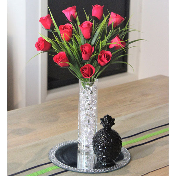 12 Red Roses in Quality Glassware accented with Sparkling Clear Vase Filler